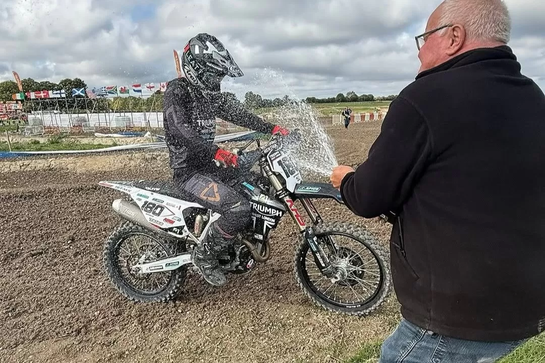 Josh Spinks celebrates on track at Foxhill aboard the Triumph TF 450-RC after winning the final race and clinching the British Masters Pro title.