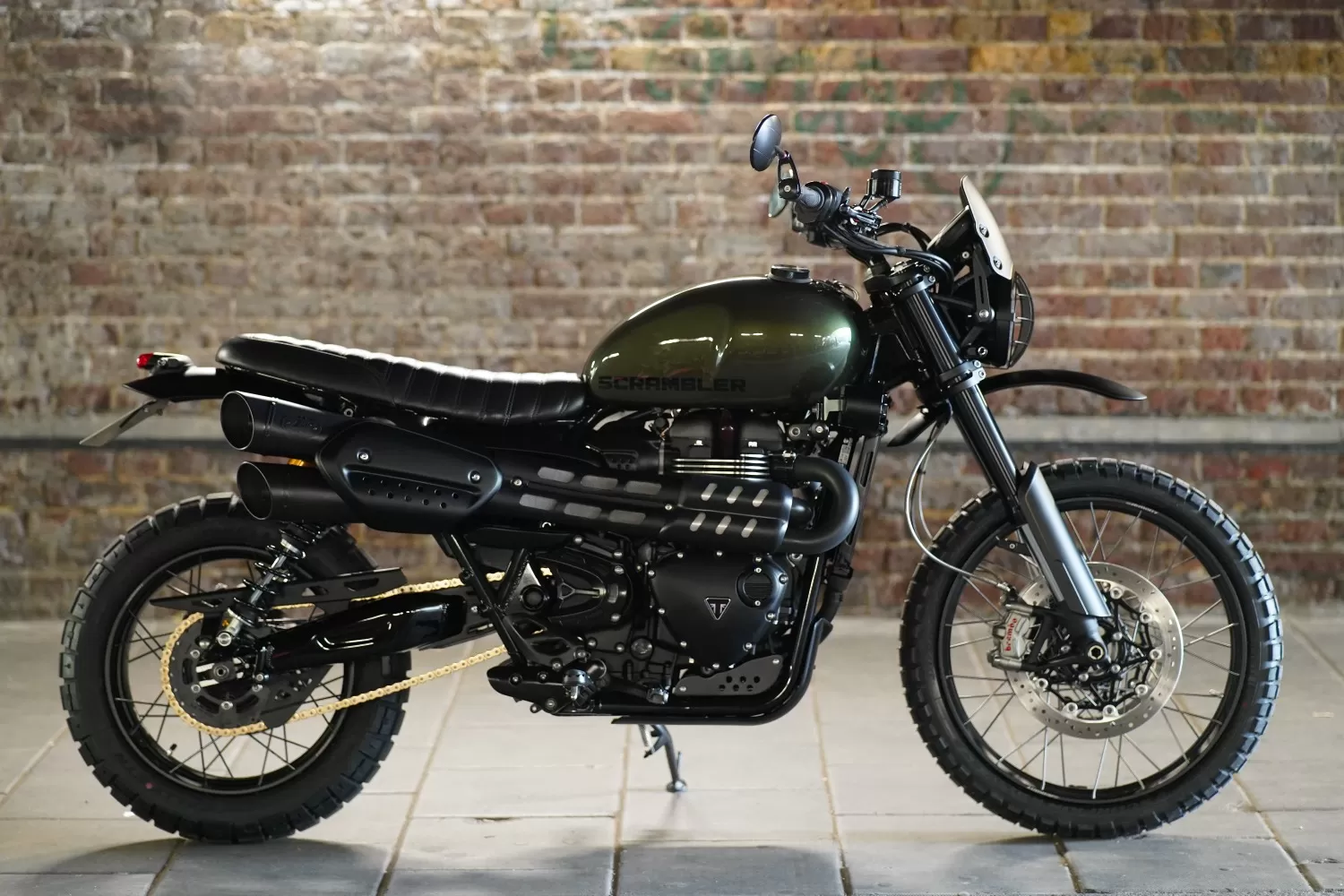 The Pine Scrambler custom Triumph motorcycle by Triumph London x Stockwell Design, side profile shot under the Vauxhall railway arch in London.